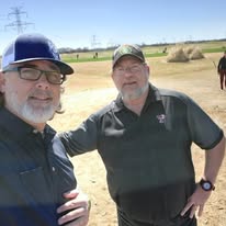 Two veterans together on the course on a clear afternoon